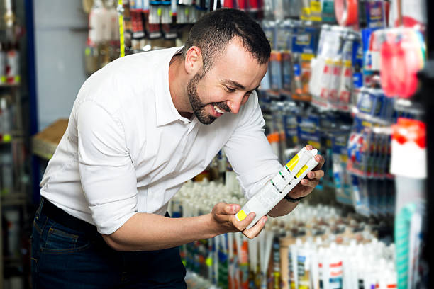 istock Man choosing sealant tube 542102908