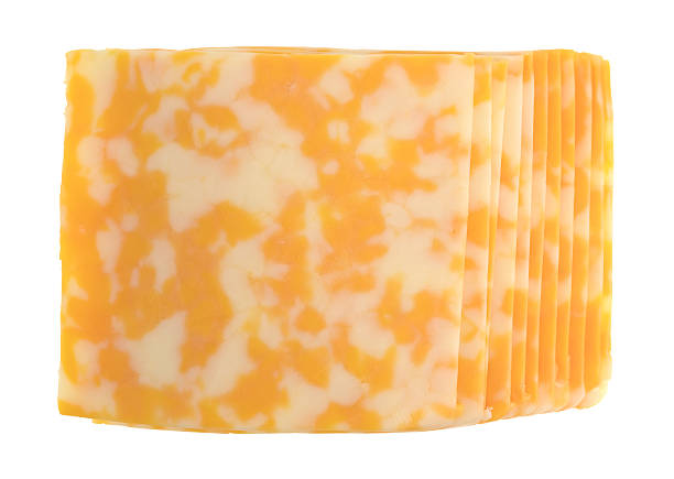 Slices of Colby-Jack cheese on a white background Top view of a stack of Colby-Jack cheese slices isolated on a white background. colby cheddar stock pictures, royalty-free photos & images