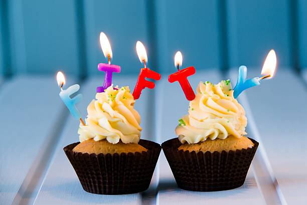 cupcake with a candles for 50 - fiftieth birthday Birthday's cake - cupcake with a candles for 50 - fiftieth birthday . Happy birthday ! fiftieth stock pictures, royalty-free photos & images