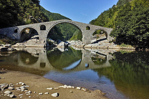 istock Reflection of Devil's Bridge in Arda river and Rhodopes mountain 542105624