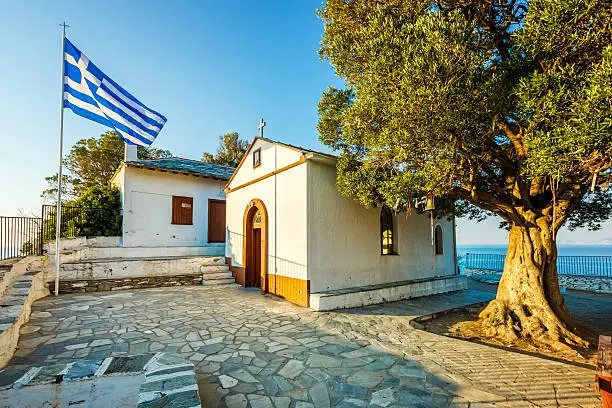 Rock with famous church Agios Ioannis Kastri on Skopelos island, Greece at sunset, where scenes of Mamma Mia! movie were filmed.