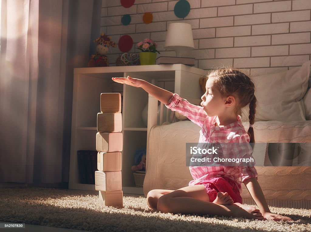 girl playing with blocks Happy child girl playing with blocks and having fun. Child Stock Photo