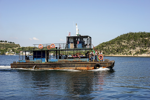 Trinidad, Cuba - January 11, 2016: Old rusty crowded ferry that sails between islands in the bay of Santiago de Cuba on the island's southern part