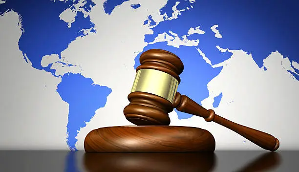 International law system, justice, human rights and global business concept with a gavel and world map on background 3D illustration.