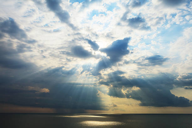 istock Cloudy seascape after storm seeing natural sunbeams at sunset. 542110026