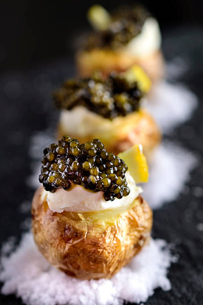Baked Potatoes with Black Caviar and Sour Cream