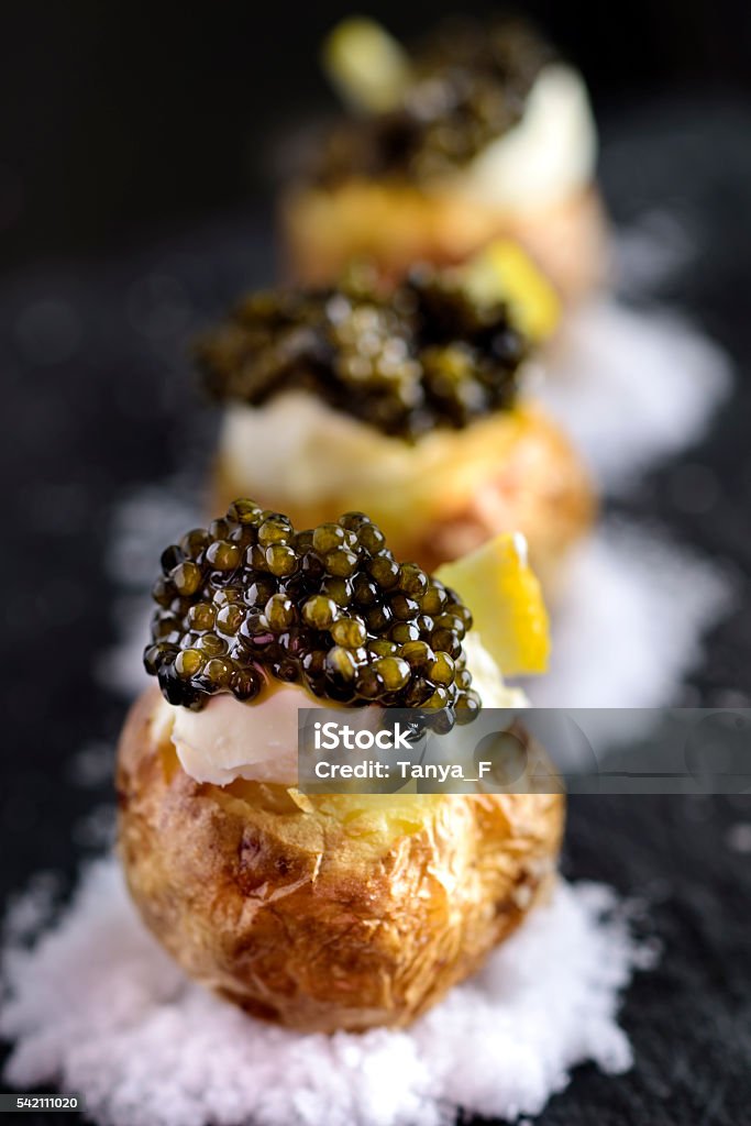 Baked Potatoes with Black Caviar Baked Potatoes with Black Caviar and Sour Cream Caviar Stock Photo