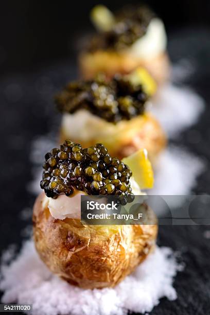 Baked Potatoes With Black Caviar Stock Photo - Download Image Now - Caviar, Appetizer, Luxury