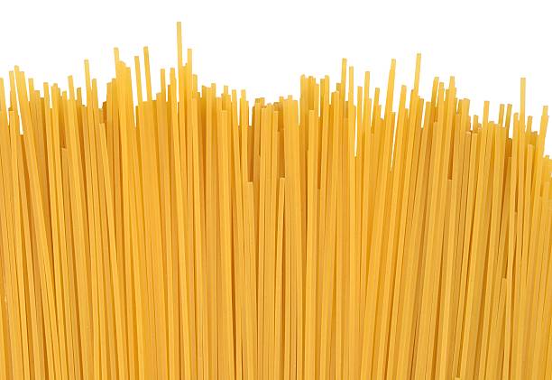istock Uncooked Italian pasta spaghetti on a white 542111082