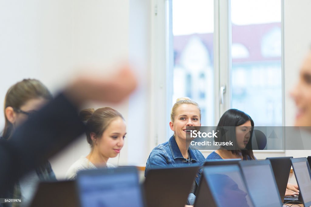 Female students learning computer programming Group of female students coding on laptops in a computer lab.  Computer Language Stock Photo