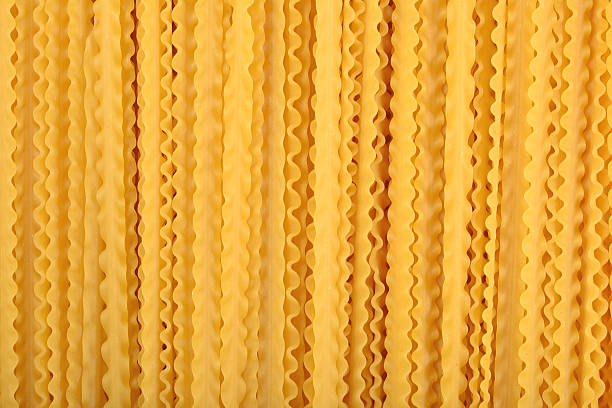 istock Uncooked Italian pasta mafaldine background 542112440