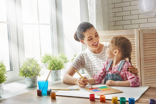 istock Mother and daughter together paint 542112448