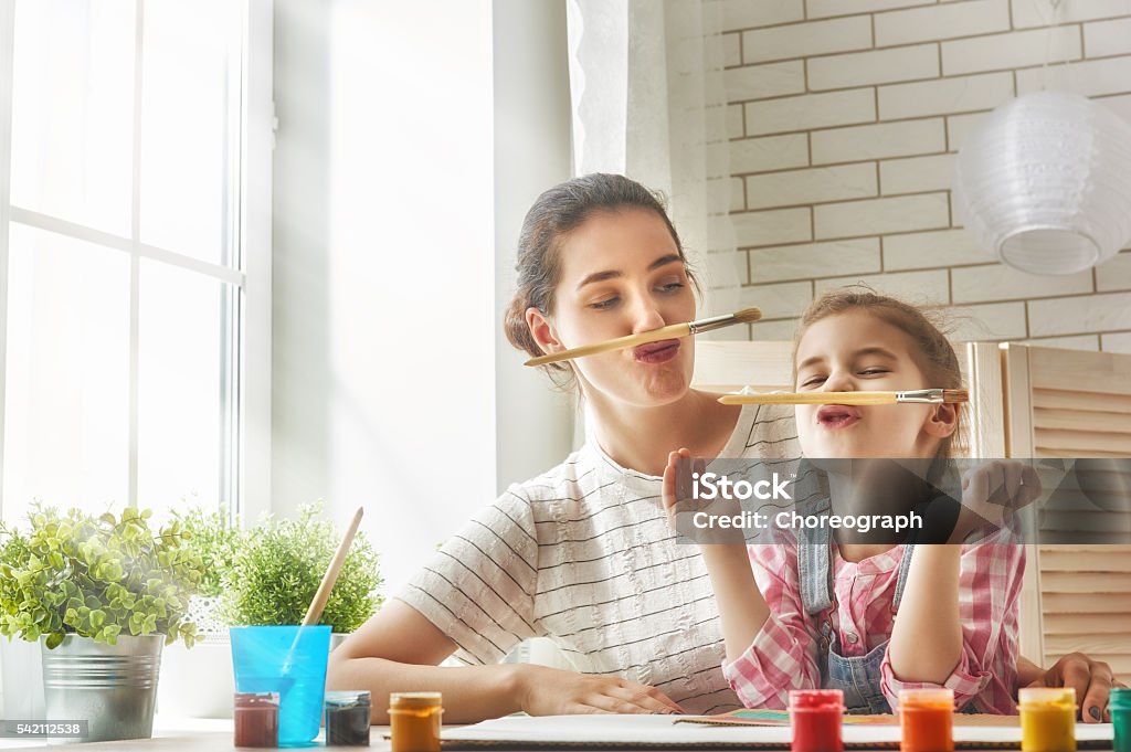 Mother and daughter together paint Happy family. Mother and daughter paint together and fooling around. Mother Stock Photo