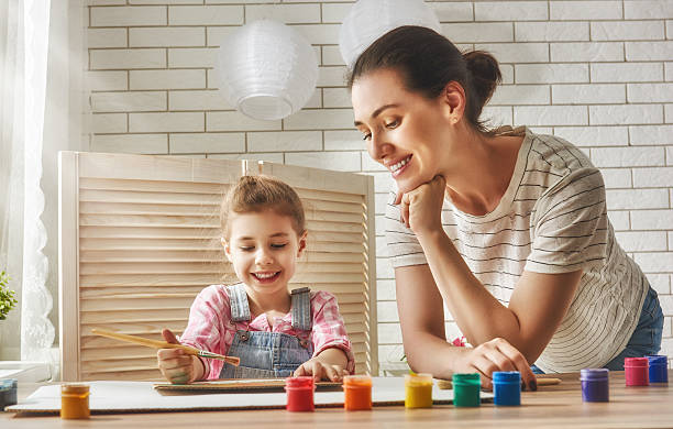 istock Mother and daughter together paint 542170598