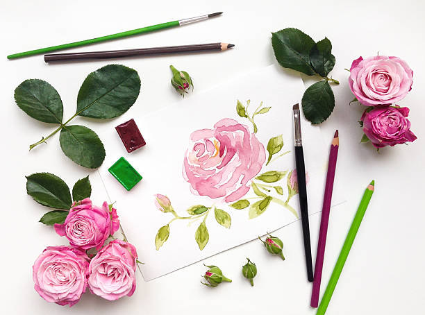 Colorful composition with roses and painting accessories. Flat lay