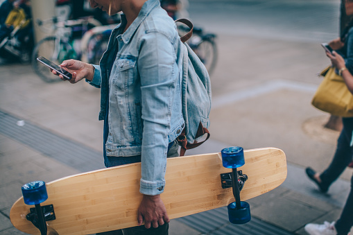 Portrait of a skater girl choosing her skateboard as a mode transportation