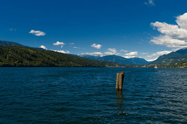 Austrian Lake of Millstat with Alps and puffy Clouds stock photo