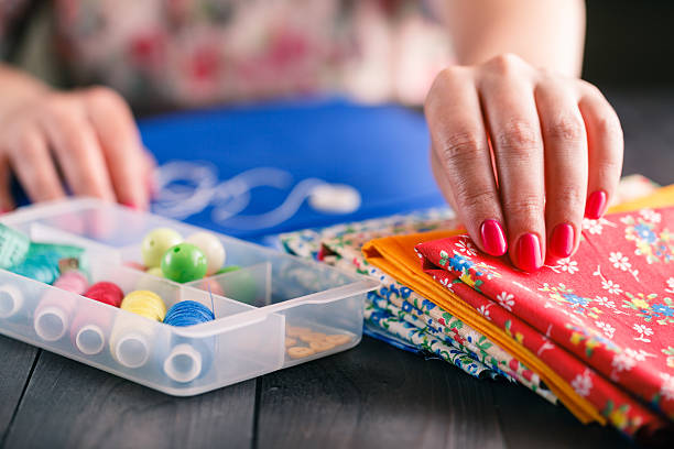 istock Senior women sews by hand 542173462
