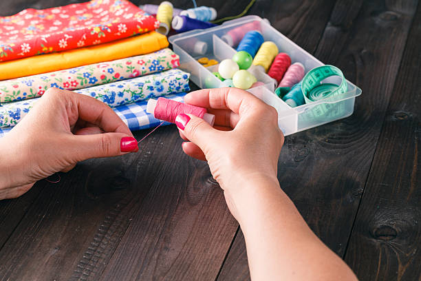 istock Senior women sews by hand 542173708