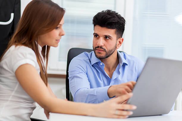 istock Two young business partners discussing plans or ideas at meeting 542174396