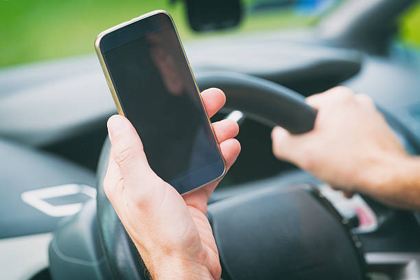 istock Man with smart phone in the car 542176138