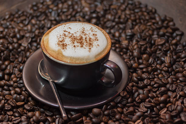 istock cappuccino coffee over roasted coffee beans as background 542176338