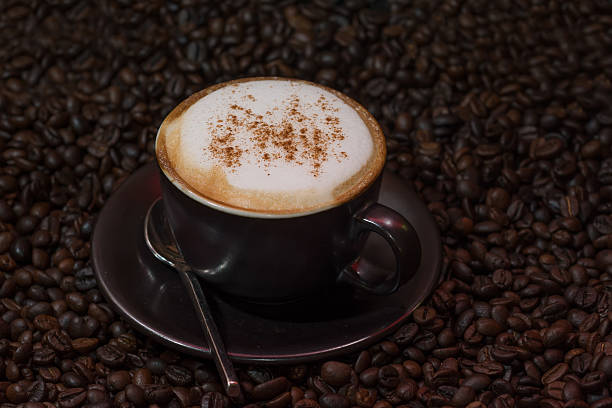 istock cappuccino coffee over roasted coffee beans as background 542176402