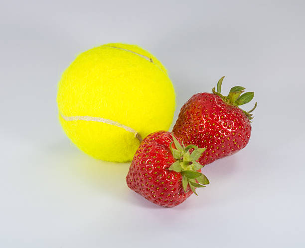 istock Wimbledon - Tennis Ball and Two Strawberries 542180132