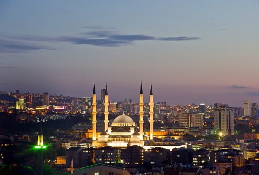 Ankara, Turkey - May 19, 2016: Kocatepe mosque interior in the dusk. Every day local people and tourists are visiting the mosque and praying. Photography of slow shutter spead. The Kocatepe Mosque is the largest mosque in Ankara, the capital of Turkey. It was built between 1967 and 1987 in the Kocatepe quarter in Kızılay, and its size and prominent situation have made it a landmark that can be seen from almost anywhere in central Ankara.