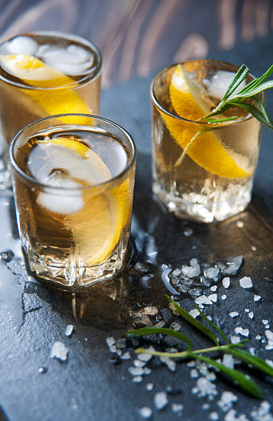 istock Alcohol cocktail with ice and smoking rosemary on dark table 542186728