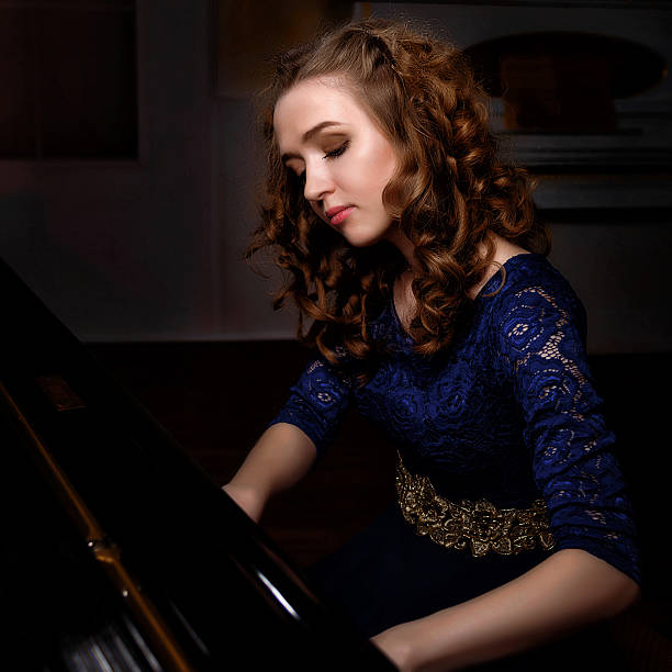 istock Young woman playing the grand piano 542186996