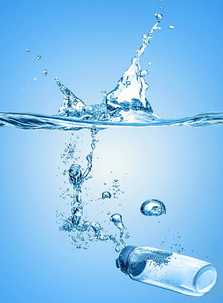 istock The moisturizing shampoo, cosmetic liquid,  thermal water falls into the blue water 542187528