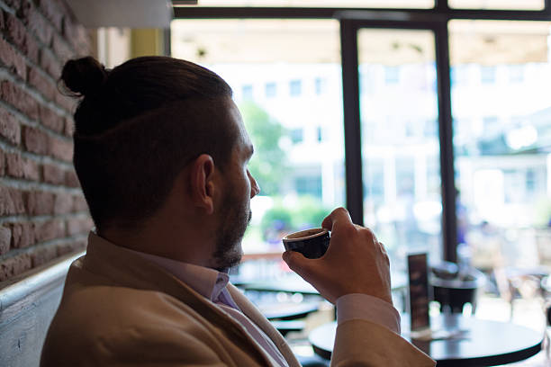 istock Confident successful businessman in suit enjoying a cup of coffe 542187586