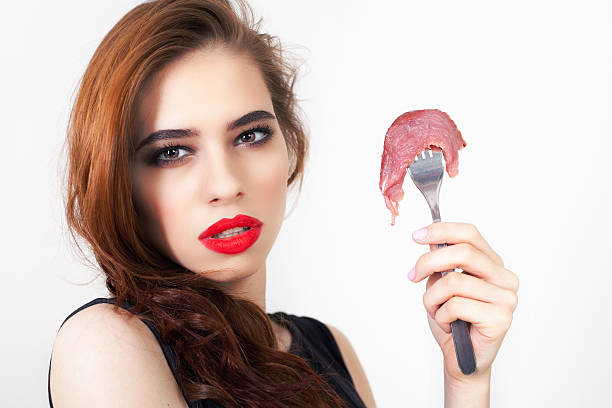istock Woman holding fork with piece of meat. Cooking. 542190204
