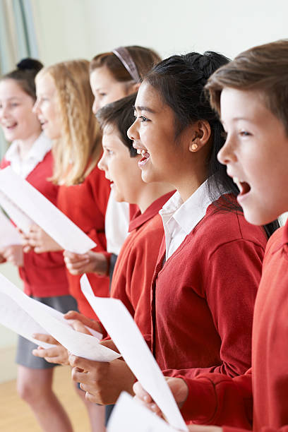 istock Group Of Children Singing In School Choir 542191564