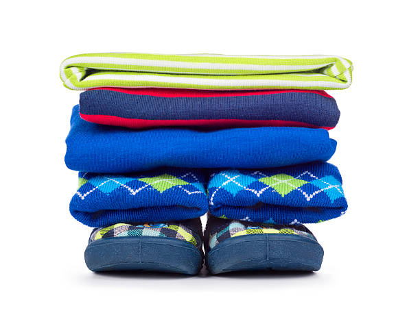 istock Pile of children's clothes isolated on white 542192226