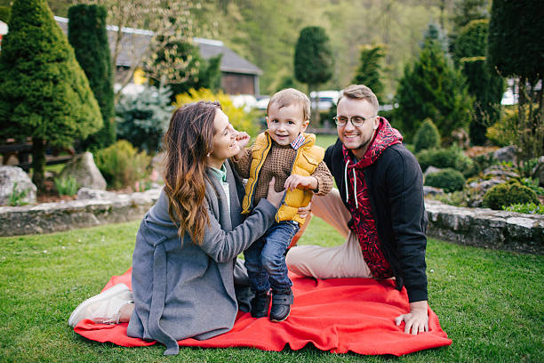 Happy young family, father mother and son on picnic outdoors stock photo