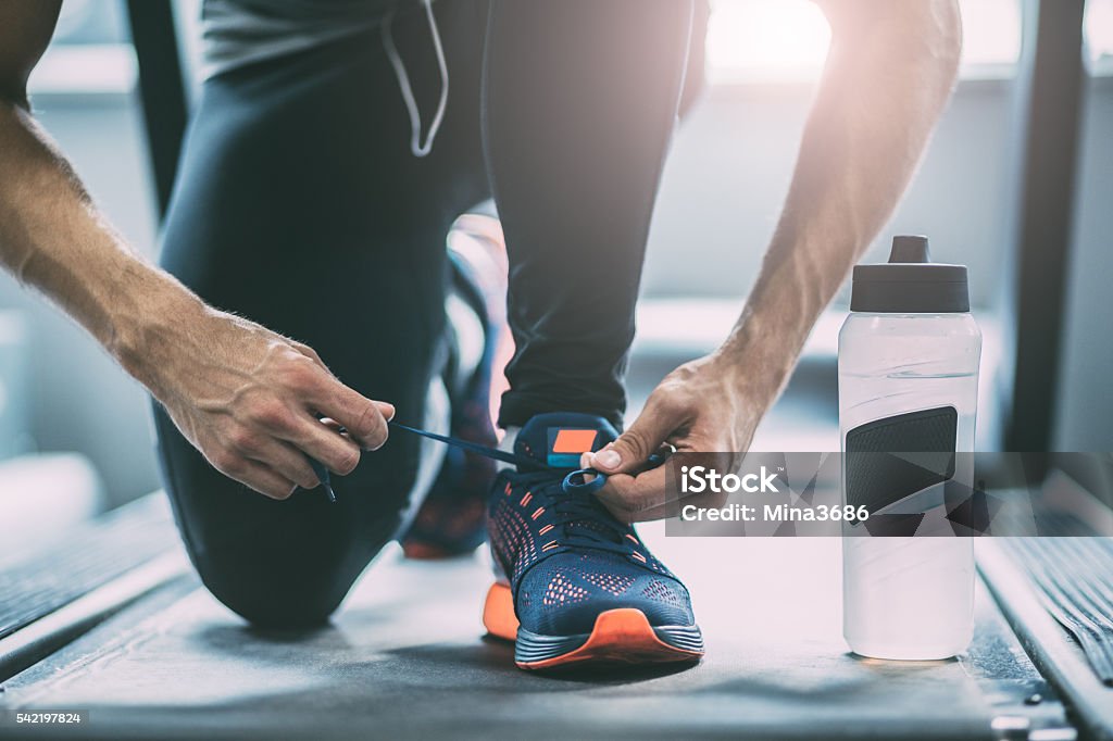 Portrait of a man tying shoelaces Men Stock Photo