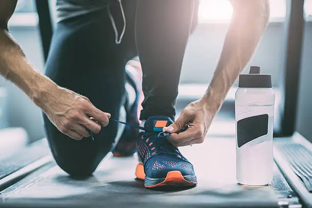 Portrait of a man tying shoelaces