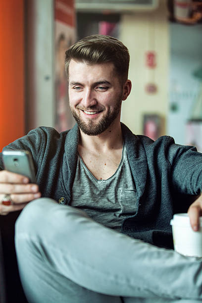 istock Bearded man  in a coffee shop and reading sms 542198618