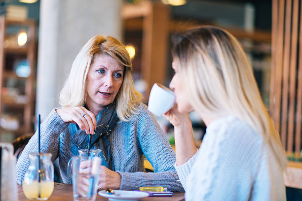 istock Mature and young woman having coffee time and chat 542200142
