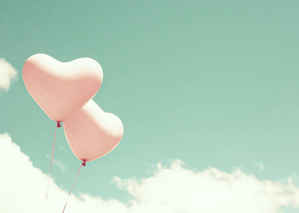 istock Pink heart shaped balloons 542200392