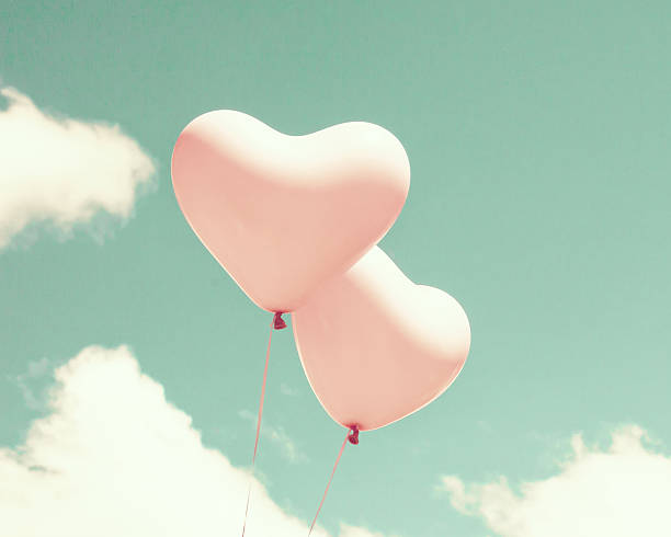 istock Pink heart shaped balloons 542200418