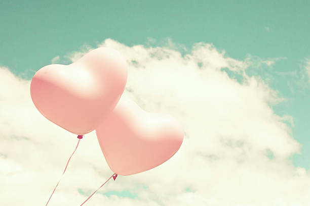 istock Pink heart shaped balloons 542200442