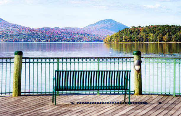 istock New England lake at Autumn with bench in front panorama 542200628