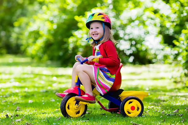 istock Cute little girl riding a tricycle 542201890