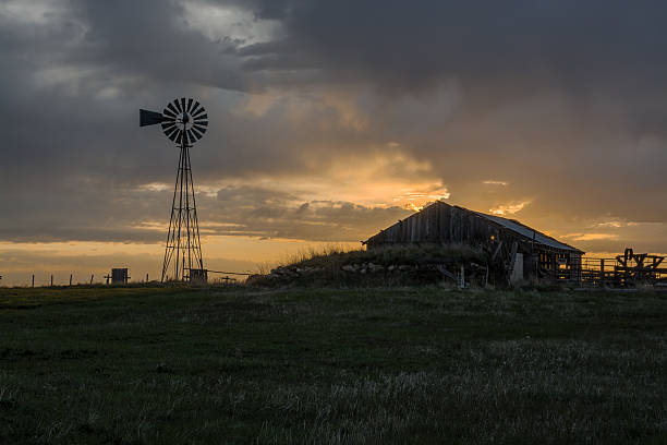 istock Sunrise on Windmill and Old Barn in South Dakota 542204220