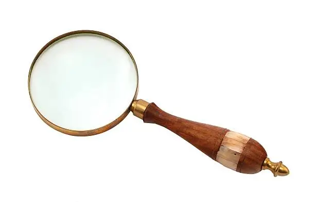 Antique-style magnifying glass with a wooden handle isolated on white background