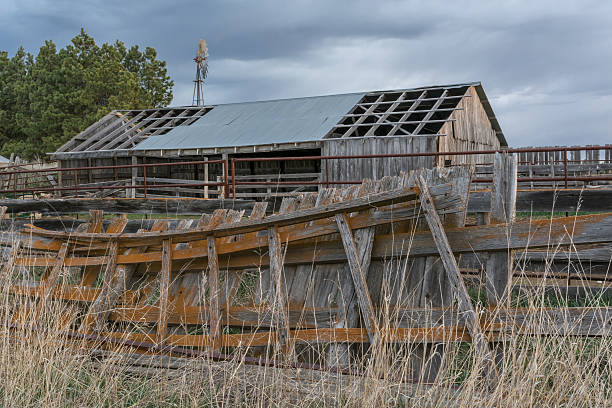 istock Sunrise on Windmill and Old Barn in South Dakota 542204466