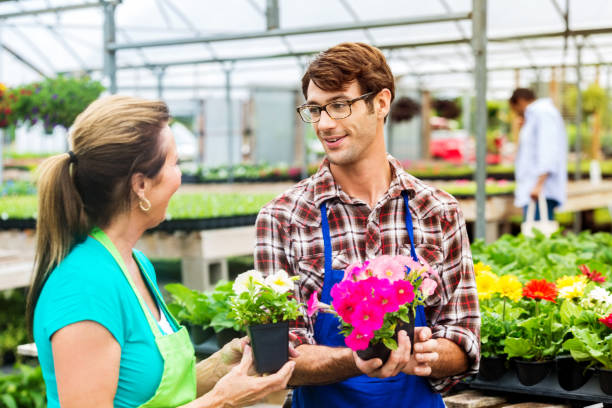istock Garden center employees discuss flowers 542204506